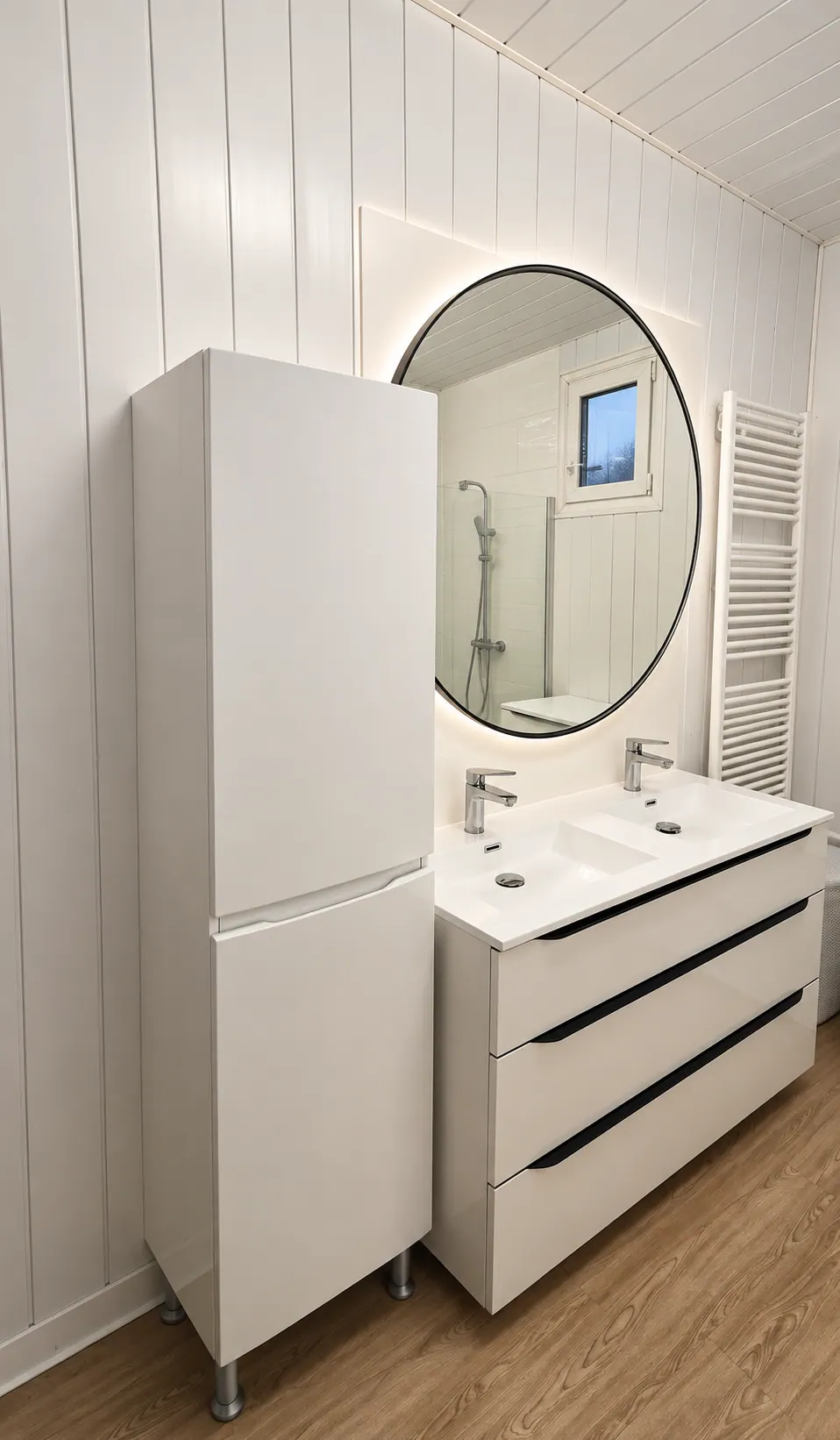 Salle de bains rénovée : meuble double vasque, colonne et miroir rond
